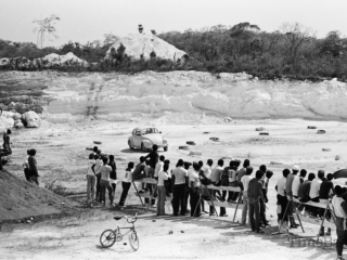 Car racing behind Triple  C