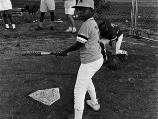 Child playing softball, 1991