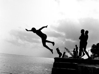 Children jumping off dock in George Town Harbour, 1986
