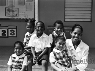 Miss Teen Cayman Islands with school children, 1999